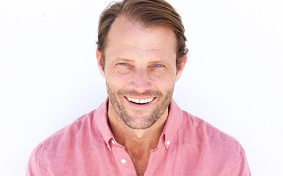male-fashion-model-smiling-against-white-wall-ZFGJQD4.jpg